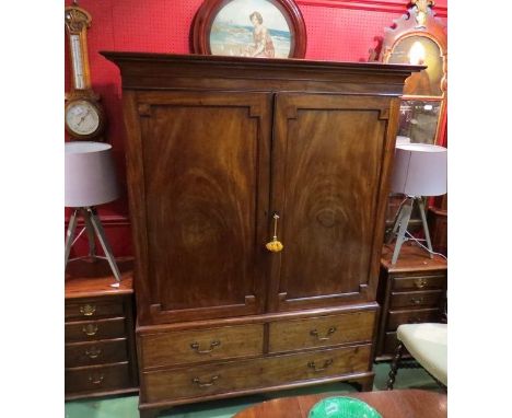 An early Victorian mahogany full hanging wardrobe the two doors over faux base drawers on bracket feet (with key) 134cm wide 