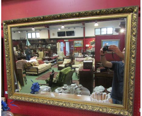 A gilt framed wall mirror, 66cm x 96cm overall
