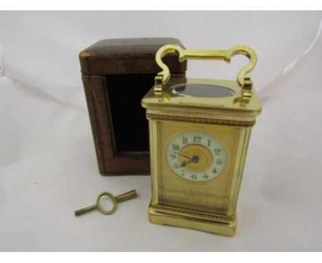 A French brass carriage clock with original travel case (with front cover), and key. Enamelled dial, circa 1900