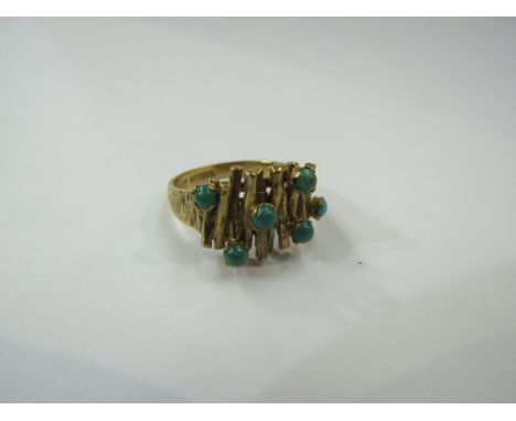 A 9ct gold ring the textured mount set with turquoise cabochon. Size O/P, 4.9g