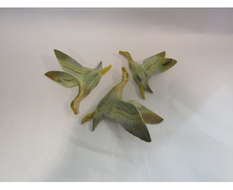 Three ceramic flying ducks
