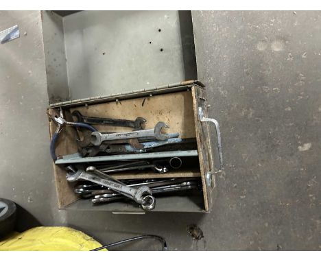 A metal storage trunk and assorted hand tools