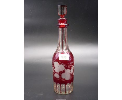 A vintage Bohemian Decanter in red glass cut to clear, 13 1/4'' tall including stopper with etched vine detail.