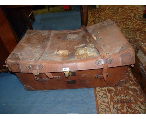 A large leather cased, wicker Travel Trunk, linen lined, having leather straps and labels, 3' long x 22" x 16" tall.
