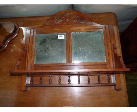 A Mahogany Wall Shelf with bevelled edge mirror back, and turned detail to undershelf, 22'' wide x 21'' high overall.