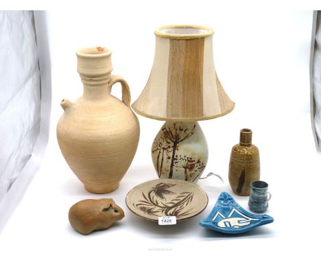 A quantity of pottery items including table lamp, ewer, guinea pig, ashtray etc.