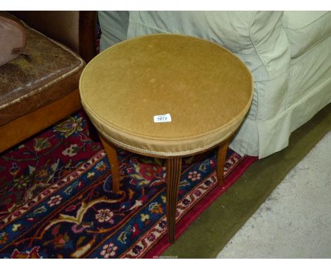 A 19th century light Mahogany circular Stool with over-stuffed horse hair seat upholstered in mustard coloured material havin