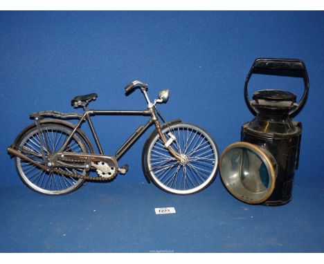 A black B.R. lamp and a small display bicycle.