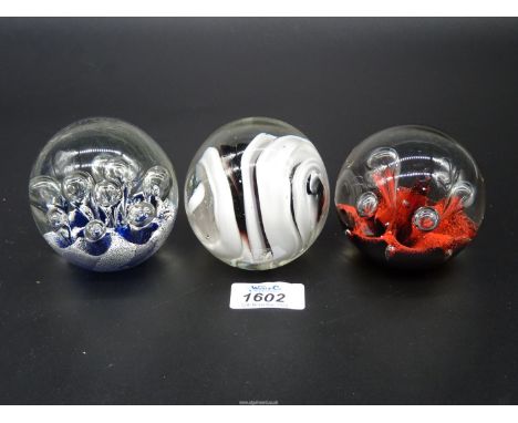 Three glass Paperweights including Caithness 'Moonflower', white and black swirl etc.