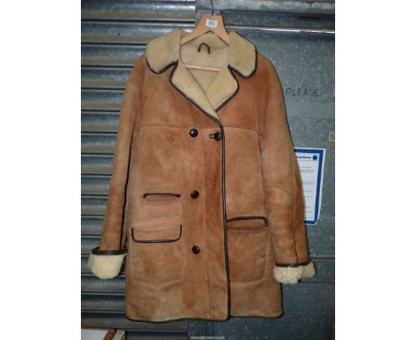 A gents Sheepskin Coat with button front, and large pockets, by Shearlings International, size L.