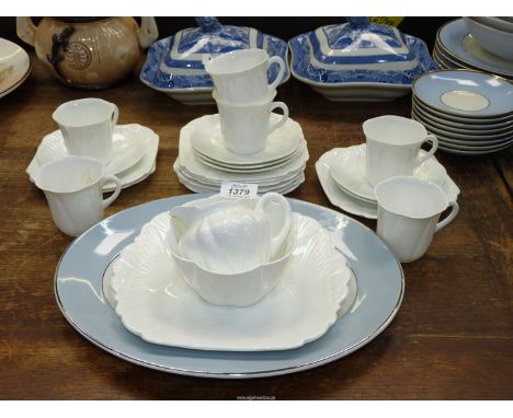 A Shelley white ground part Teaset comprising cake plate, six cups and saucers (one cup a/f.), nine tea plates, jug and sugar