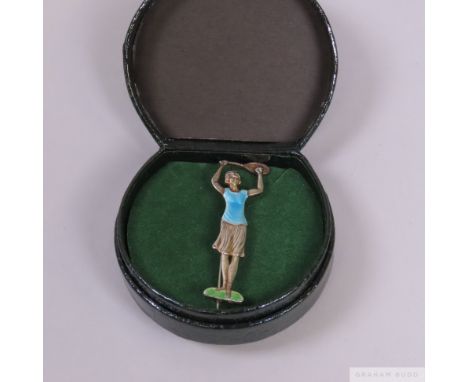 An Art Deco enamelled lady tennis player silver brooch,&nbsp; in the form of a lady tennis player holding a racquet above her