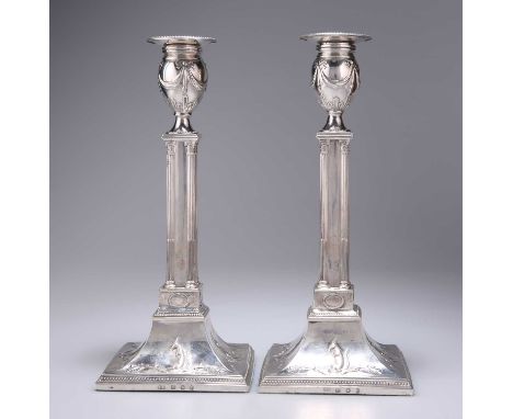 A PAIR OF GEORGE III SILVER CANDLESTICKS by Daniel Holy &amp; Co, Sheffield 1777, the detachable nozzle with a beaded rim abo