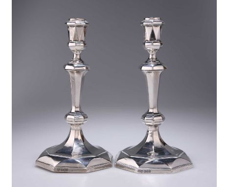 A PAIR OF GEORGE V SILVER CANDLESTICKS by Hawksworth, Eyre &amp; Co Ltd, Sheffield 1919, each with an octagonal domed diamond