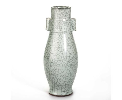 A CHINESE GUAN-TYPE VASE, HU well potted with a slender ovoid body, the neck flanked by a pair of tubular lug handles, covere