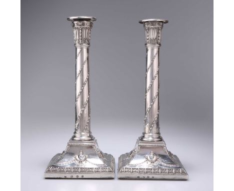 A PAIR OF GEORGE III SILVER CANDLESTICKS by Joseph Tibbitts, Sheffield 1776, beaded nozzles above fluted foliate sconces, eac