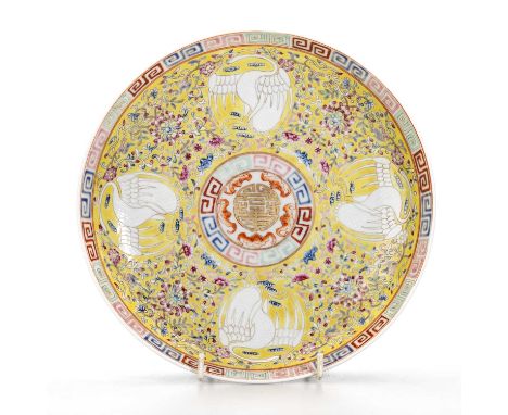 A CHINESE FAMILLE ROSE SAUCER DISH enamel painted with four cranes, lotus and scrolling foliage, on a yellow ground. 21cm dia