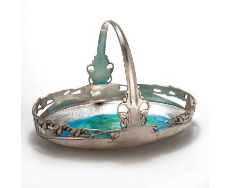 ARCHIBALD KNOX (1864-1933) FOR LIBERTY & CO, A TUDRIC PEWTER AND ENAMEL CAKE BASKET no. 0359, of oval form, the pierced galle