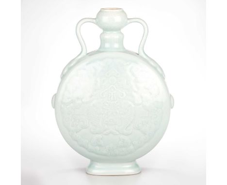 A CHINESE PORCELAIN MOON FLASK each side carved with a design of double fish among billowing clouds, the base with a seal mar