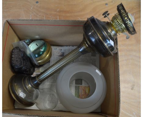 A mixed lot of collectables to include an oil lamp (af), a tribal carving, a reproduction clock and a telescopic cup.