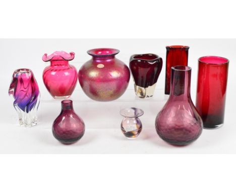A small collection of ruby coloured art glass including large and small matching vases by Caithness, a Wedgwood vase, a Darti