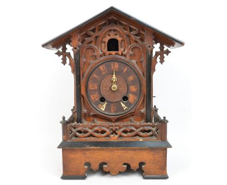 A late 19th century Black Forest mantel cuckoo clock with carved and pierced decoration, front and side gallery, shaped apron