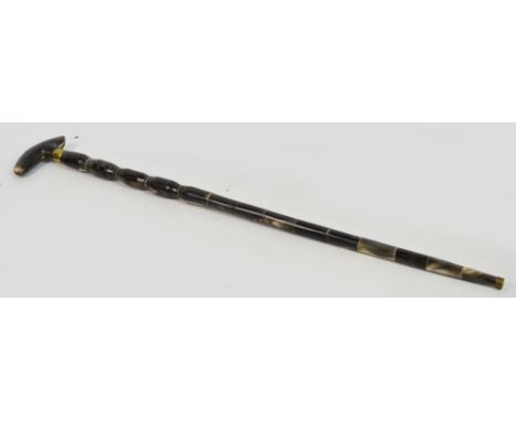 An early 20th century sectional horn walking stick with brass collar, height 85cm.