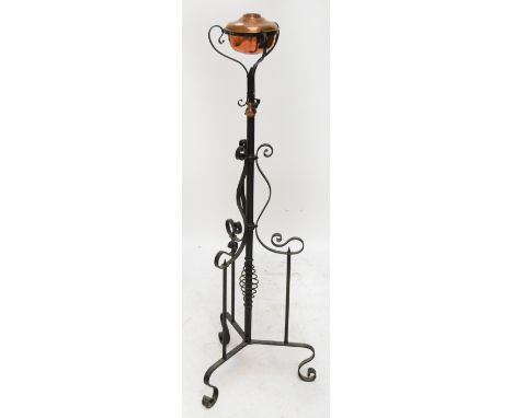 An Art Nouveau style wrought iron telescopic standard lamp (formerly an oil lamp).