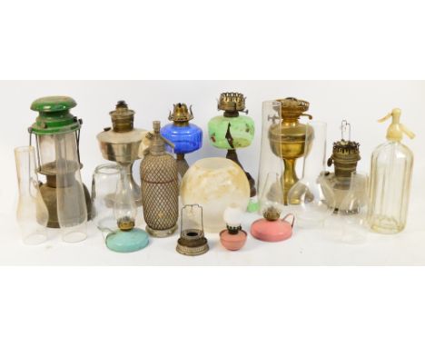 A quantity of vintage lamps including a Model 300 X Bialaddin, an oil lamp with blue glass reservoir and various shades and c