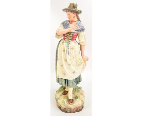 A large c.1900 German majolica figure of a peasant woman, impressed marks to base "Gesetzlich Geschutzt", no. 53, height 73cm