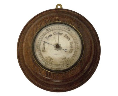 An oak cased circular aneroid barometer, indistinctly inscribed "Liverpool", diameter 28cm.