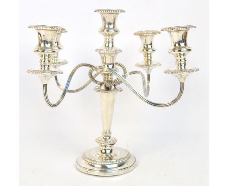 An Elizabeth II hallmarked silver candelabrum with four wrythen branches to the tapering stem raised on loaded circular sprea