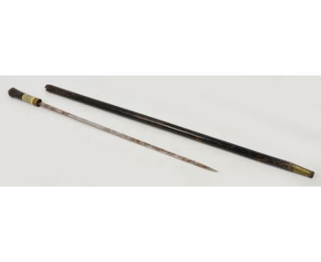 An ebonised sword stick with brass and bone collar, brass finial and ferrule, with ethnic incised decoration, length 91cm.