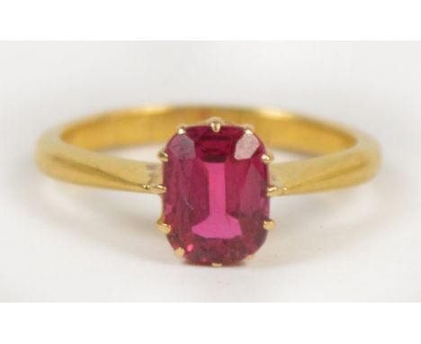 A unmarked yellow gold and single stone ruby ring, the rounded rectangular stone weighing approximately 0.80cts, size I 1/2