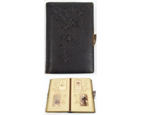 A Victorian/Edwardian photograph album with embossed cover and gilt clip fastening, with many portrait photographs in shaped 