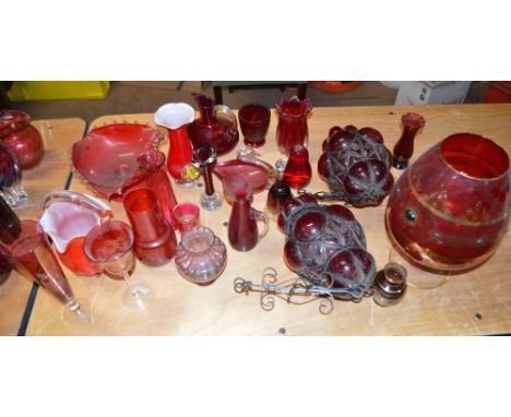 A collection of ruby coloured glass including a large gilt heightened brandy glass shaped vase, two Moroccan style lamp shade