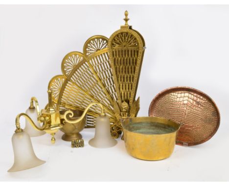 A decorative brass firescreen modelled as a mythical beast, a brass jam pan, a brass jardinière, a brass model of the three w