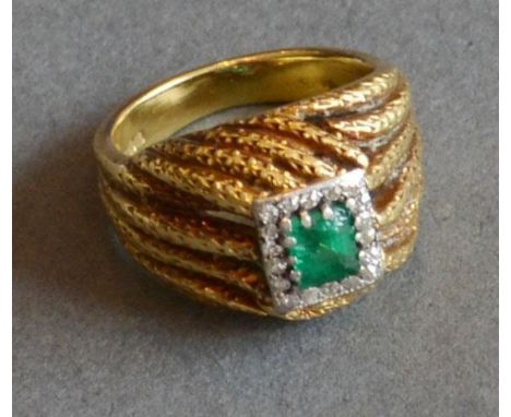 An 18ct. Yellow Gold, Emerald and Diamond Ring, a central square emerald surrounded by diamonds, 11.2g 