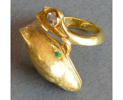 An 18ct. Gold Ring In The Form Of A Dolphin with emerald eyes and a single diamond to the tail, 10.7g 