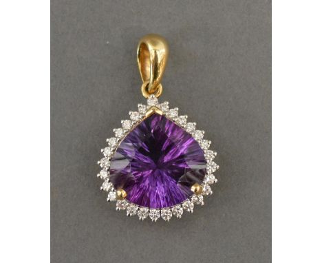 An 18ct. Gold, Amethyst And Diamond Pendant, set with a large Amethyst surrounded by diamonds, within a pierced setting 