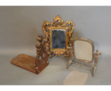 A Patinated Metal Table Mirror Together With A Brass Framed Wall Mirror and a Gothic revival oak book stand 