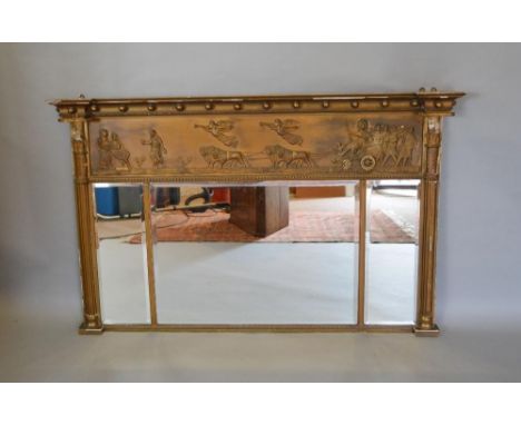 A Regency Gilded Over Mantle Mirror With A Ball Cornice above a relief decorated frieze with classical figures and chariots a