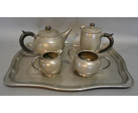 A Tudric Pewter Four Piece Tea Service, together with a Warric beaten pewter tray with Cricket related presentation inscripti