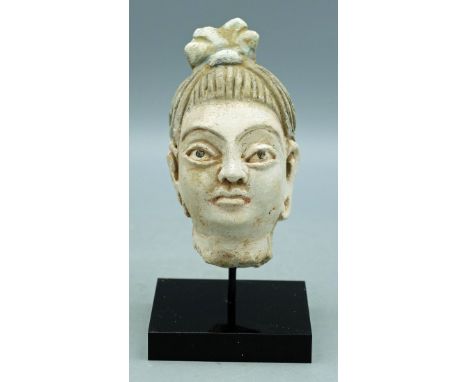 A choice Gandharan stucco head from the Indus Valley, ca. 4th - 5th Century AD. This large example is 4 in. high and portrays
