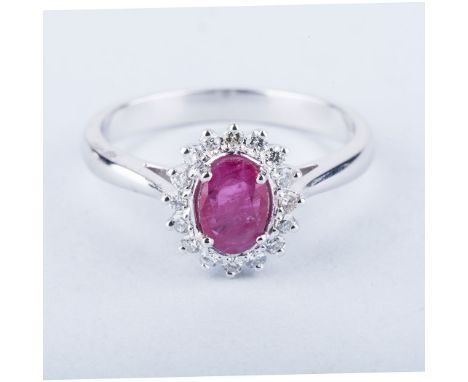 A RUBY AND DIAMOND RING centred with an oval mixed-cut ruby weighing approximately 0.52cts, the conforming surround claw-set 
