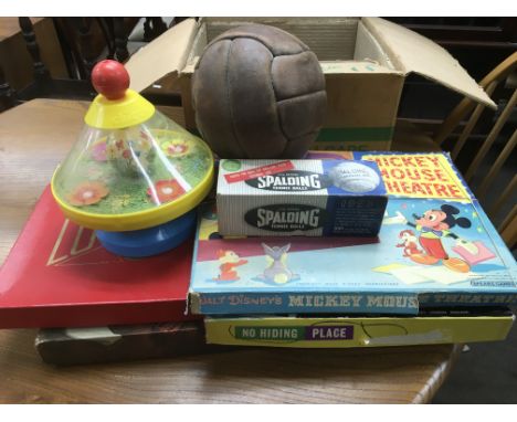 A box of toys and games and some vintage curtains.