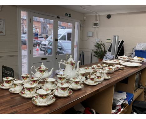 A Royal Albert tea and dinner service set in the Country Roses pattern.