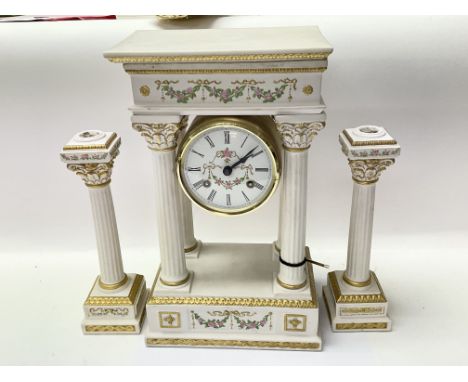 A white porcelain portico clock empress Josephine Germany hermle, working. There is no winding key. The clock is gilded with 