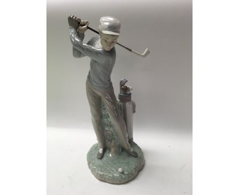 A Lladro figure in the form of a golfer .