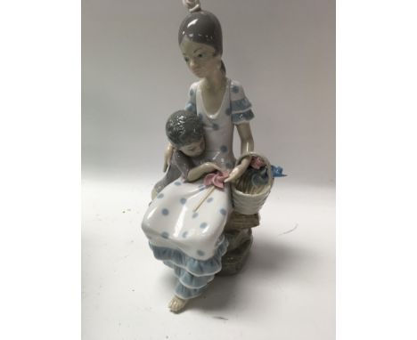 A Lladro figure mother and son . With box